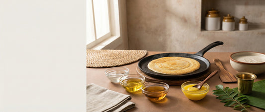 Indian tawa with crispy dosa surrounded by coconut oil, groundnut oil, sesame oil, and ghee, showing healthy cooking oil options for dosa and tawa recipes.