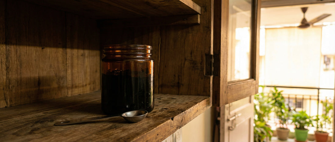 Amber glass jar of Shilajit resin stored safely in a cool dark cupboard to prevent melting in the Indian climate