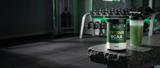 NXTShift BCAA powder 250g bottle with electrolytes and taurine placed on a gym bench with Indian gym background Pure Nutrition product review 2026