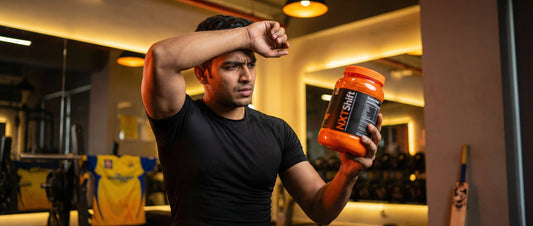 Indian gym user holding NXTShift pre workout supplement in gym