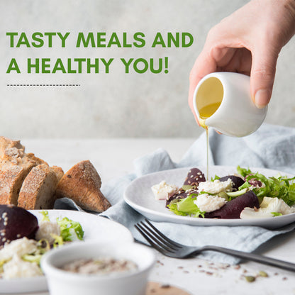 Virgin olive oil being poured over a fresh salad, highlighting its use for healthy meals and flavorful cooking.